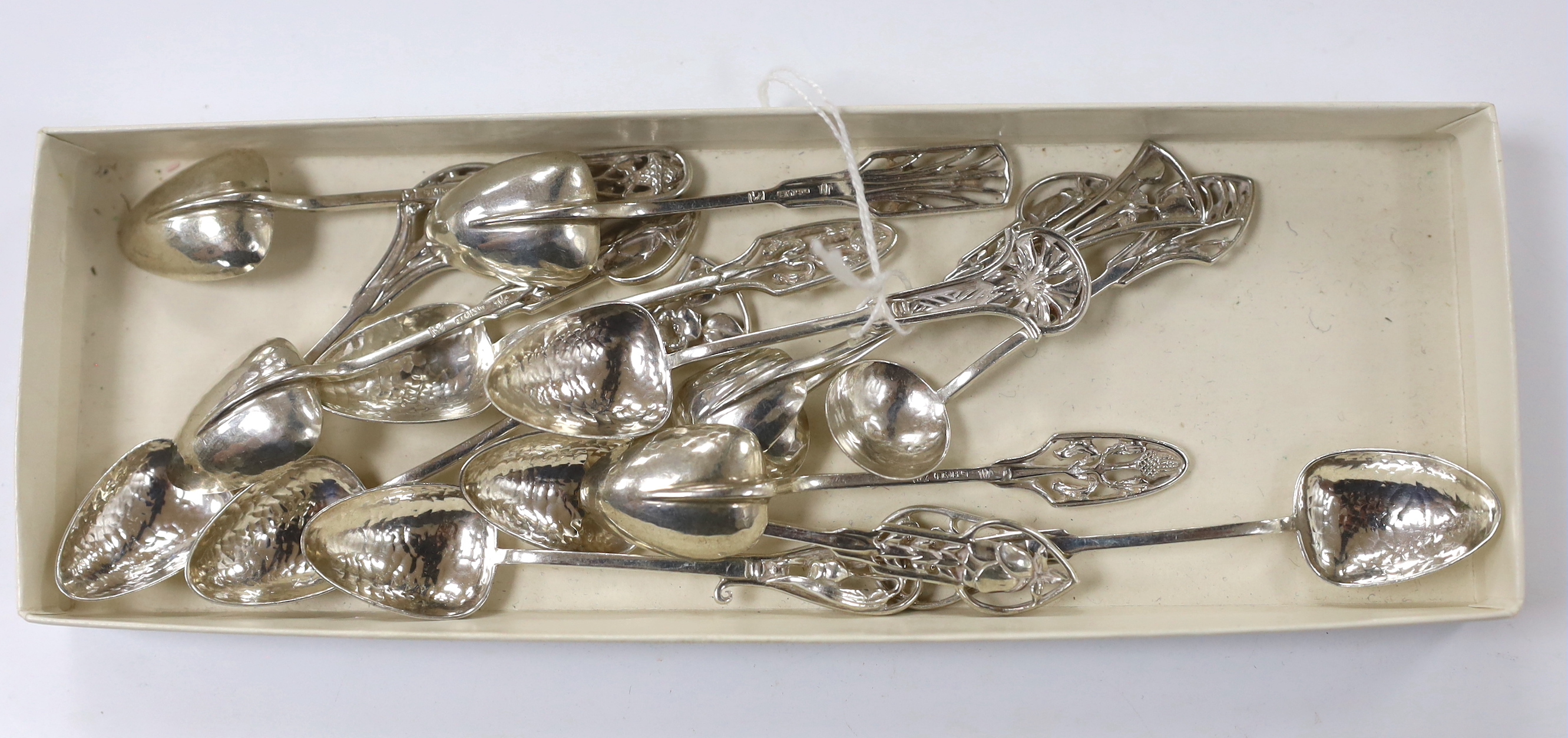 Fourteen Australian Arts & Crafts small sterling spoons by James A. Linton, with planished bowls and differing floral terminals, largest 86mm, 3.4oz.